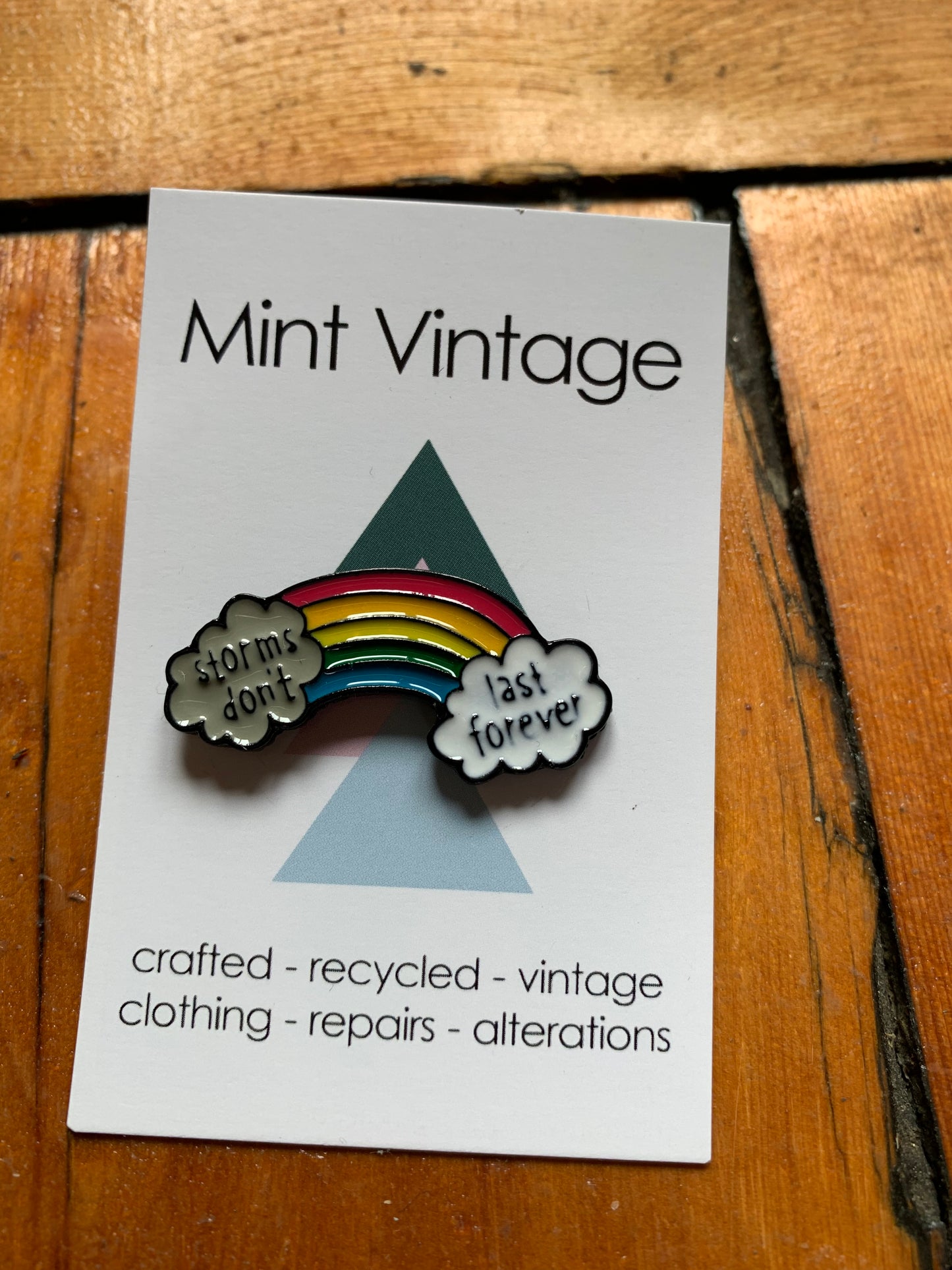 Rainbow “storms don’t last forever” pin badge